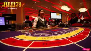 Ang larawan ay isang baccarat table na may babaeng dealer